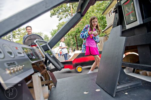 Alexa Talmadge checks out the delorean from the movie Back to the Future before the start of the 4th annual Madison Ave. Soap Box Derby in Decatur on Saturday, September 27, 2014.