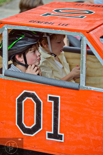 Jackson Lee (left) adjusts his helmet as he and his brother Sawyer wait for the start of the 4th annual Madison Ave. Soap Box Derby in Decatur on Saturday, September 27, 2014.
