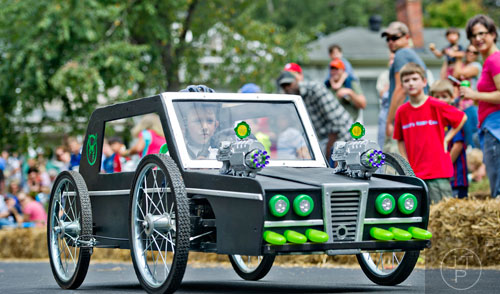 Cy Jacobson steers his car from the movie The Green Hornet down Madison Ave. in Decatur during the 4th annual Madison Ave. Soap Box Derby on Saturday, September 27, 2014.