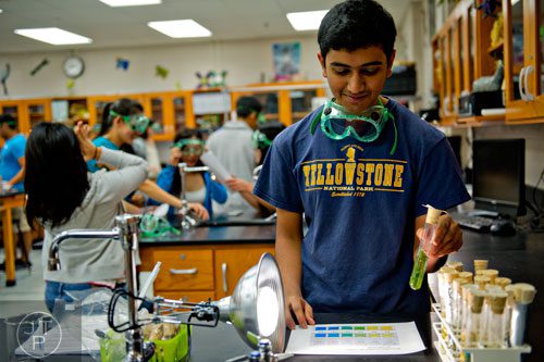 Sanket Mehta works on a lab during his biology class at Walton High School on Tuesday, October 14, 2014. 