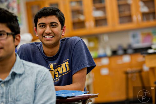 Sanket Mehta takes notes during his biology class at Walton High School on Tuesday, October 14, 2014. 
