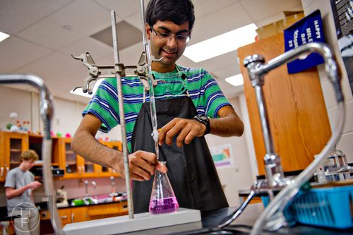 Haroon Alam works on a chemistry lab at Walton High School on Tuesday, October 14, 2014. 