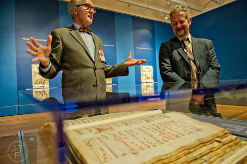 Gary Radke (left) and Lorenzo Fabbri discuss Psalm 81, the ink and tempera on parchment piece by Filippo di Matteo Torelli, on display in the High Museum of Art's new "Make a Joyful Noise": Renaissance Art and Music at Florence Cathedral exhibit on Tuesday, October 14, 2014.  