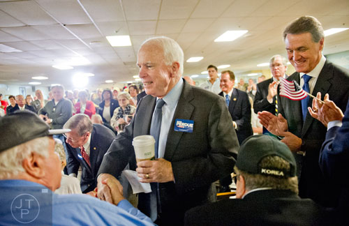 Senator John McCain (left) and Republican candidate David Perdue shake hands with a group of veterans before speaking at the VFW Post 2681 in Marietta on Wednesday, October 15, 2014. 