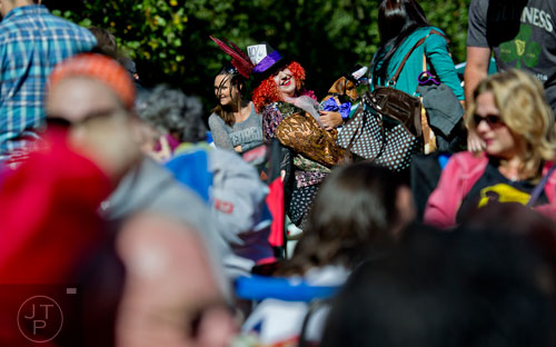 Emma Waters (center) holds her dachshund Penny as they wait for the start of the costume contest during Howl-O-Weenie at Liane Levetan Park at Brook Run in Dunwoody on Saturday, October 4, 2014. 