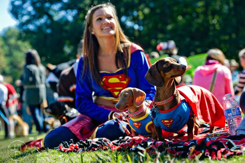 Browning (right) and Bella sit with their owner Sarah Beth Snider as they prepare for the costume contest during Howl-O-Weenie at Liane Levetan Park at Brook Run in Dunwoody on Saturday, October 4, 2014. 