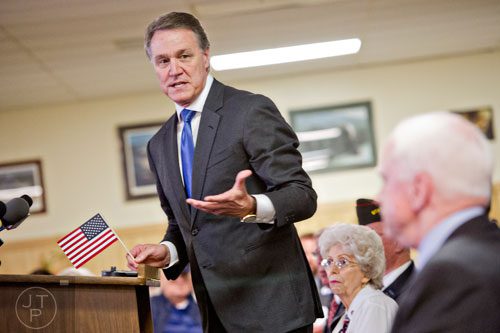 Republican candidate David Perdue (left) speaks to a crowd of supporters at the VFW Post 2681 in Marietta with senators John McCain and Johnny Isakson on Wednesday, October 15, 2014. 