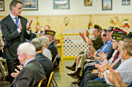 Republican candidate David Perdue (left) applauds the veterans sitting behind him as he speaks at the VFW Post 2681 in Marietta with senators John McCain and Johnny Isakson on Wednesday, October 15, 2014.