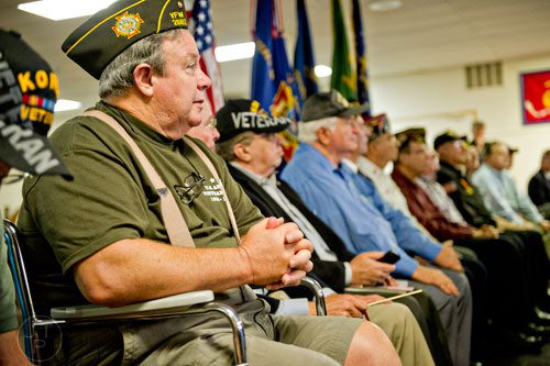 Vietnam War veteran Ronnie Rogers (left) listens to Republican candidate David Perdue speak at the VFW Post 2681 in Marietta on Wednesday, October 15, 2014.