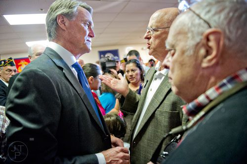 Republican candidate David Perdue (left) speaks with Michael Opitz after speaking at the VFW Post 2681 in Marietta with senators John McCain and Johnny Isakson on Wednesday, October 15, 2014. 