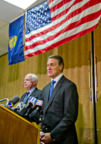 Republican candidate David Perdue (right) and Senator John McCain answer questions by members of the media after speaking at the VFW Post 2681 in Marietta on Wednesday, October 15, 2014.