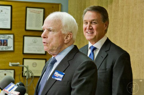 Senator John McCain (left) and Republican candidate David Perdue answer questions by members of the media after speaking at the VFW Post 2681 in Marietta on Wednesday, October 15, 2014. 