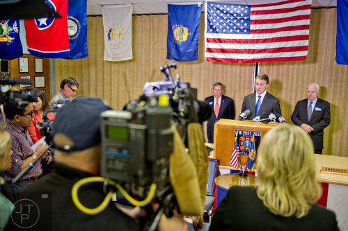 Senator Johnny Isakson (right), candidate David Perdue and Senator John McCain answer questions by members of the media after speaking at the VFW Post 2681 in Marietta on Wednesday, October 15, 2014.