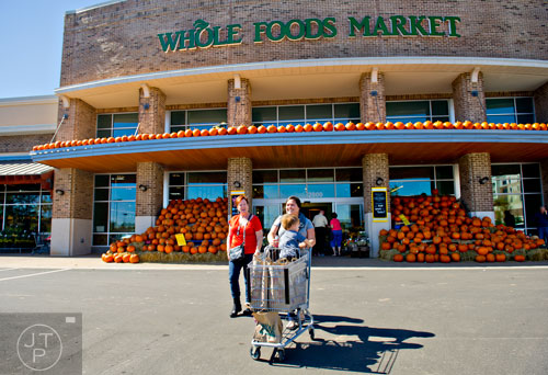Miles Henderson rides in a shopping cart as his mother Roxy and grandmother Tami Mohamed finish shopping at the Whole Foods Market inside the new Avalon development in Alpharetta on Friday, October 17, 2014. 