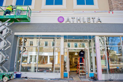 Don Robinson (right) installs a door at the entrance to Athleta as construction continues at the new Avalon development in Alpharetta on Friday, October 17, 2014. 
