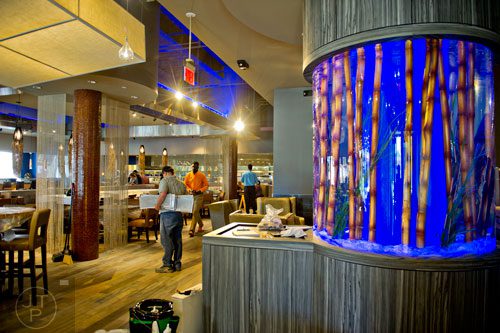A fishtank inside the Kona Grill glows blue as workers put on the finishing touches at the new Avalon development in Alpharetta on Friday, October 17, 2014. 