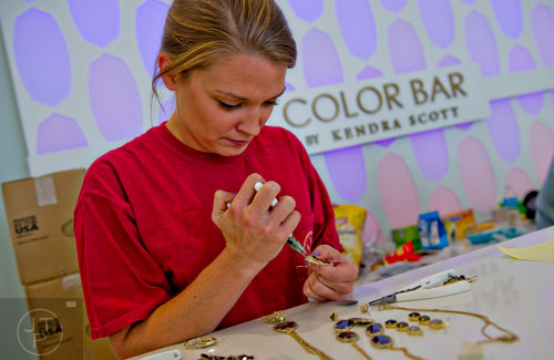 Beth Walker puts together jewelry inside the Kendra Scott store at the new Avalon development in Alpharetta on Friday, October 17, 2014. 