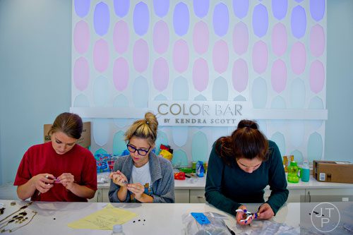 Beth Walker (left), Jillian Heaton and Ashley Frost put together jewelry inside the Kendra Scott store at the new Avalon development in Alpharetta on Friday, October 17, 2014. 