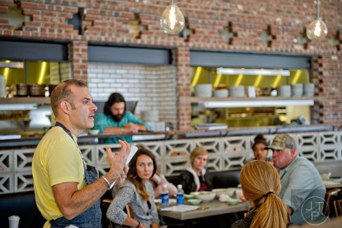 Chef Kevin Maxey (left) explains the menu to new employees at The El Felix inside the new Avalon development in Alpharetta on Friday, October 17, 2014. 