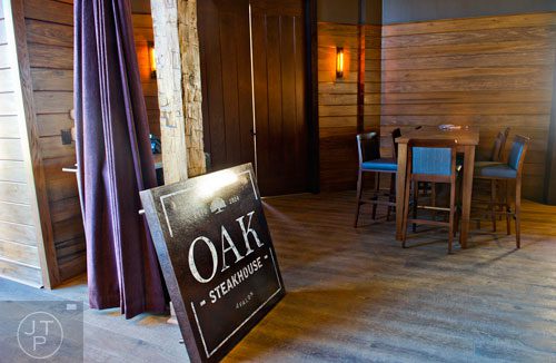 The sign for Oak Steakhouse at the new Avalon development in Alpharetta sits on the floor of the restaurant on Friday, October 17, 2014. 