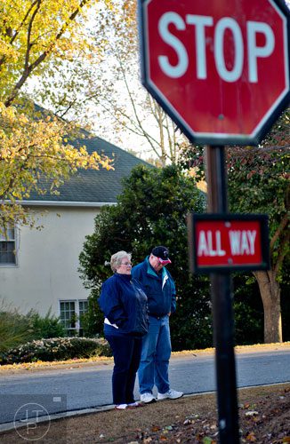 Patty Abel (left) and her husband David wait for their son Christopher and daughter Nicole to get home from school at the bus stop near their home in Acworth on Friday, November 14, 2014. 