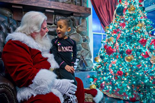 Rylee Jeter visits with Santa Claus at Six Flags Over Georgia in Austell on Friday, November 21, 2014. 