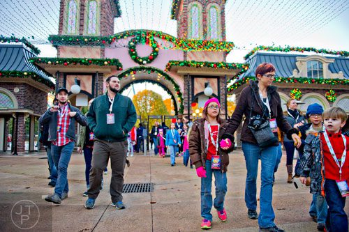 Brian Digglemann (left), Matt Bacon and Gwyn Balman and her mother Kathy and brother Rowyn walk into Six Flags Over Georgia in Austell on Friday, November 21, 2014.