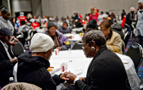 Arlene Stone (left) prays with minister Charlotte Ross during the 44th annual Hosea Feed the Hungry and Homeless Thanksgiving Holiday Dinner at the Georgia World Congress Center in Atlanta on Thursday, November 27, 2014. 