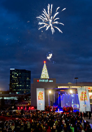 Fireworks go off above the Christmas tree on top of the Macy's building at Lenox Square Mall in Atlanta during the annual tree lighting ceremony on Thursday, November 27, 2014. 
