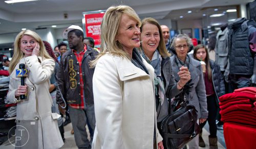 Dawn Braswell (center) and Joan Michelson walk through Macy's at Lenox Square Mall in Atlanta after doors open for Black Friday on Thursday, November 27, 2014.