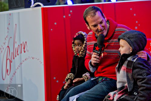 Emcee Cadillac Jack (center) interviews Carson Sims (right) and McKinley Parks during the annual Macy's Great Tree Lighting celebration at Lenox Square Mall in Atlanta on Thursday, November 27, 2014. 