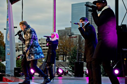 Scott Hoying (left), Kirstin Maldonado, Mitch Grassi and Kevin Olusola from Pentatonix perform on stage during the annual Macy's Great Tree Lighting celebration at Lenox Square Mall in Atlanta on Thursday, November 27, 2014. 