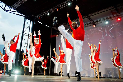 Austyn Rich (right) dances on stage with the Macy's Magical Stars during the annual Macy's Great Tree Lighting celebration at Lenox Square Mall in Atlanta on Thursday, November 27, 2014. 