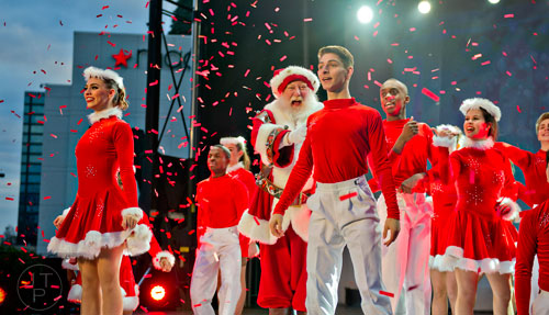 Santa Claus (center) makes an appearance on stage with the Macy's Magical Stars during the annual Macy's Great Tree Lighting celebration at Lenox Square Mall in Atlanta on Thursday, November 27, 2014. 