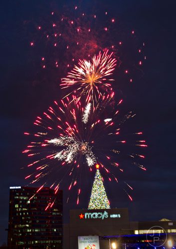 Fireworks go off above the Christmas tree on top of the Macy's building at Lenox Square Mall in Atlanta during the annual tree lighting ceremony on Thursday, November 27, 2014. 