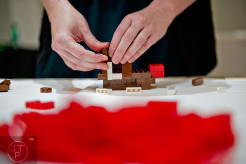 Kate Lawter builds a Rudolph the Red Nosed Reindeer sculpture using LEGOs during the LEGOLAND Discovery Center Atlanta's Brick Factor Competition at the Mandarin Oriental building in Atlanta on Sunday, November 23, 2014.