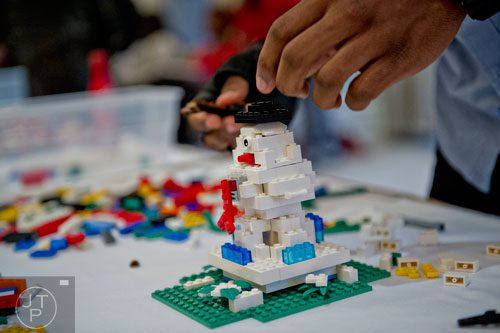 Rod Ferris builds a snowman sculpture using LEGOs during the LEGOLAND Discovery Center Atlanta's Brick Factor Competition at the Mandarin Oriental building in Atlanta on Sunday, November 23, 2014. 