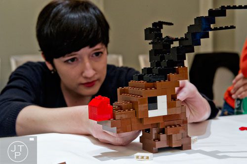Kate Lawter builds a Rudolph the Red Nosed Reindeer sculpture using LEGOs during the LEGOLAND Discovery Center Atlanta's Brick Factor Competition at the Mandarin Oriental building in Atlanta on Sunday, November 23, 2014. 