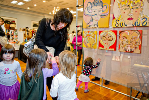 Courtney Vonwalsung (center) tries to wrangle her daughters Pearl (left), Vivian, Olive and Beatrice as they shop during the 10th annual Indie Craft Experience Holiday Shopping Spectacular at the Georgia Freight Depot in Atlanta on Sunday, November 23, 2014.