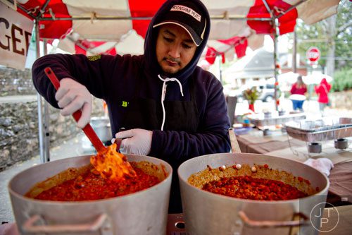 Rogelio Nino stirs vats of chili during the 12th annual Cabbagetown Chomp & Stomp in Atlanta on Saturday, November 1, 2014. 