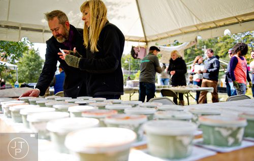 Hunter Moore (left) and Sara Williams organize chili entries for the judges during the 12th annual Cabbagetown Chomp & Stomp in Atlanta on Saturday, November 1, 2014. 