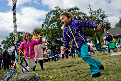 Nora Baruch (right) and her sister Shoshana run around a maypole during the 12th annual Cabbagetown Chomp & Stomp in Atlanta on Saturday, November 1, 2014. 