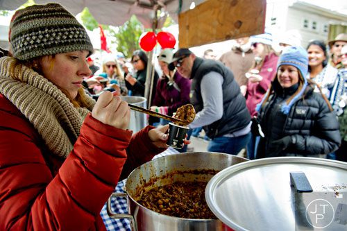 Mary Dayton (left) scoops out cups of chili during the 12th annual Cabbagetown Chomp & Stomp in Atlanta on Saturday, November 1, 2014. 