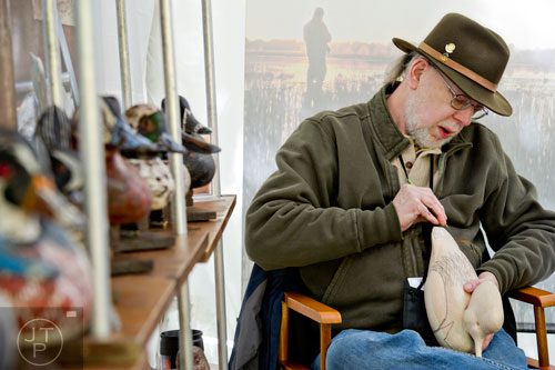 Bill Dealy preps for the finishing touches on one of his handmade duck decoys during the Chastain Park Art Festival in Atlanta on Sunday, November 2, 2014. 