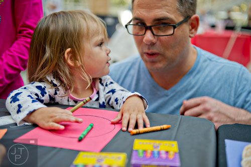 Amelia Mulligan (left) turns to her father Jeff to help her draw tree rings during Science at Hand at the Fernbank Museum of Natural History in Atlanta on Saturday, November 8, 2014. 
