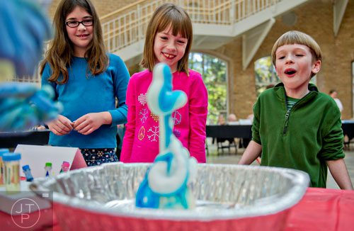 Philip Williams (right), his sister Margaret and Charlotte Baugher watch as "elephant toothpaste" explodes from a bottle during Science at Hand at the Fernbank Museum of Natural History in Atlanta on Saturday, November 8, 2014. 