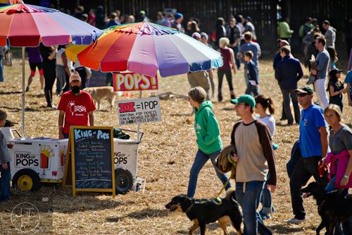 Karta Preec (left) mans one of the popsicle carts during the 4th annual King of Pops Field Day at The Masquerade in Atlanta on Saturday, November 8, 2014. 