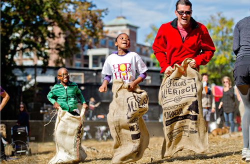 Kaden Newby (left), his sister Kendall and Michael Looney compete in a sack race during the 4th annual King of Pops Field Day at The Masquerade in Atlanta on Saturday, November 8, 2014. 