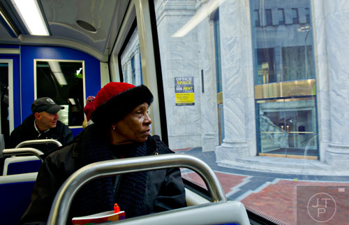 Betty Jordan (center) looks out of the window as she rides in an Atlanta Streetcar on Wednesday, December 31, 2014. 