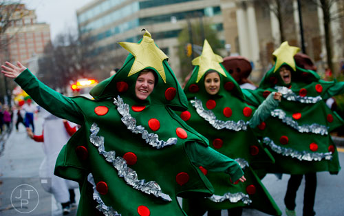 Julia Doherty (left) waves to the crowd as she walks down Peachtree St. during the 2014 Children's Christmas Parade in Atlanta on Saturday, December 6, 2014. 